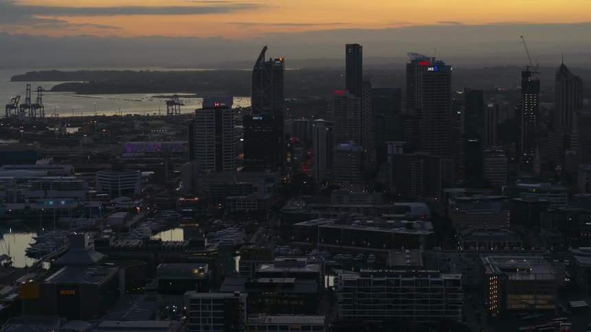 An aerial view of office buildings with construction cranes in a city