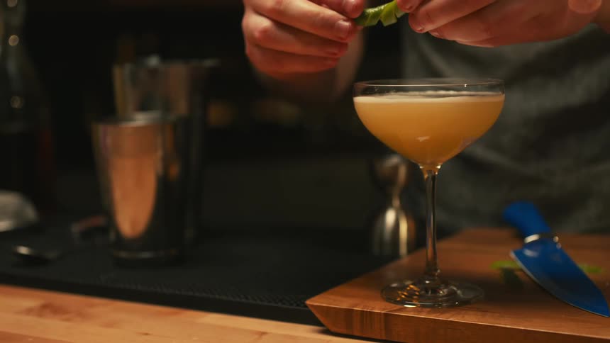 A bartender is making drinks at the bar counter