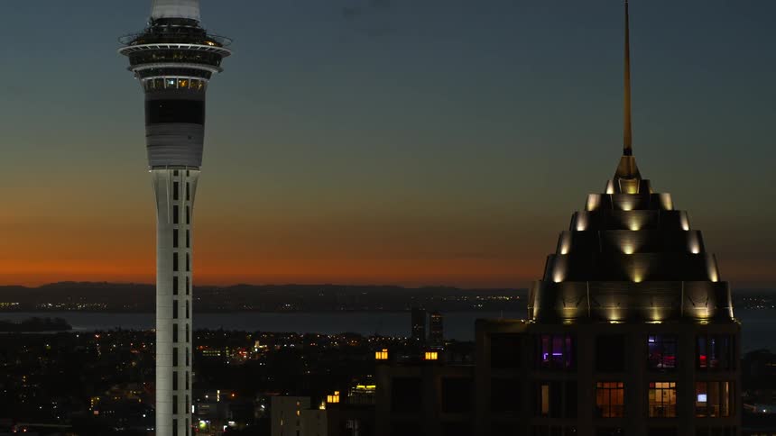 A control tower with the city skyline and coast behind it