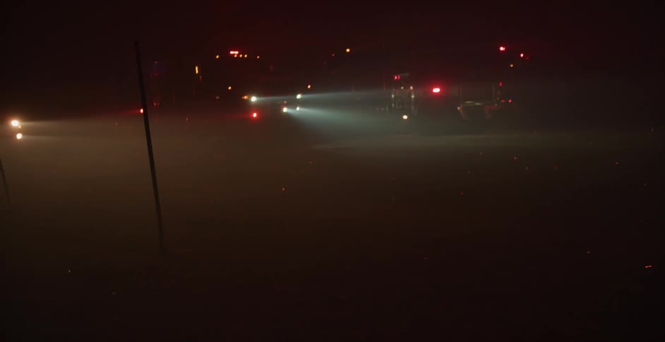Emergency vehicles are at a scene during the night