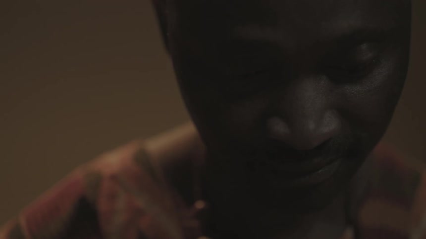 A man is looking down smiling