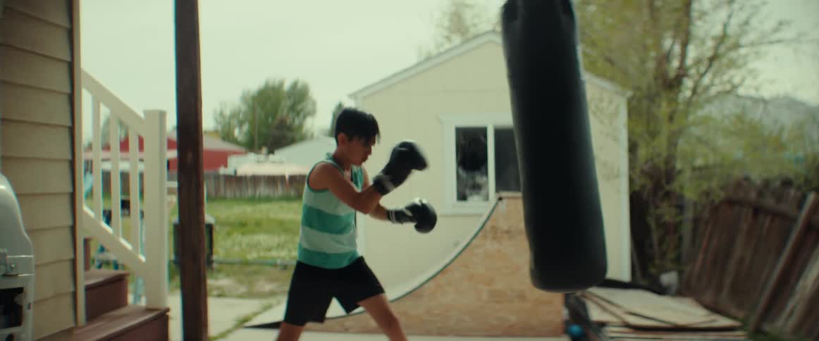 A child boxing against a bag