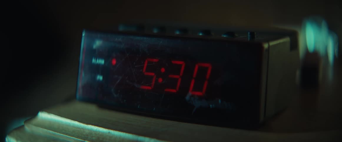An analog alarm clock goes off