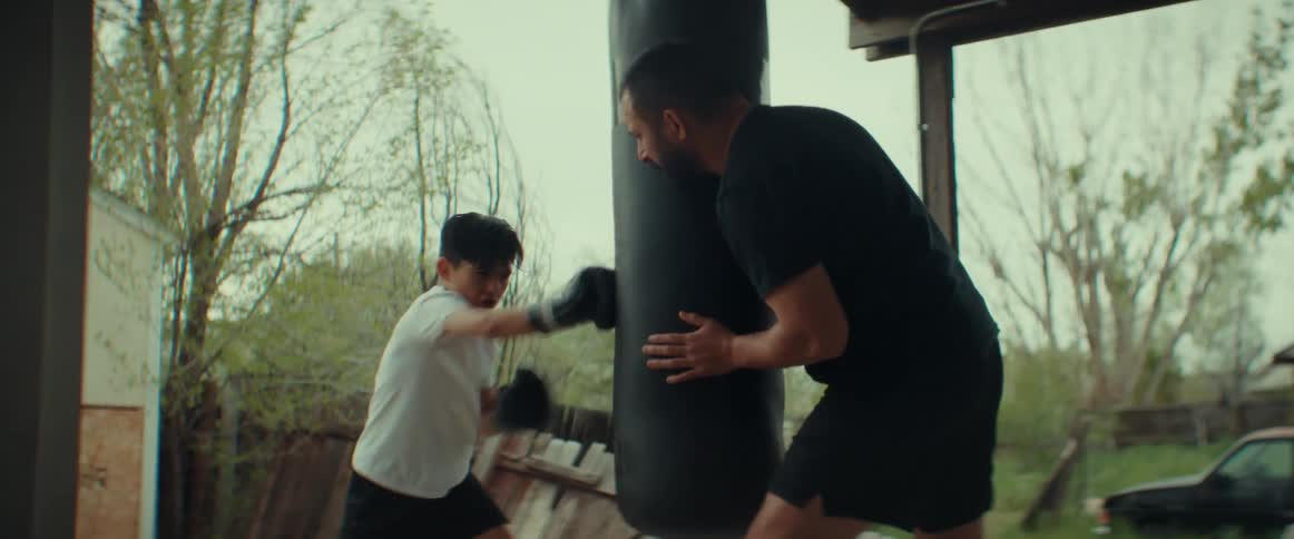 A view of a man training a child on boxing