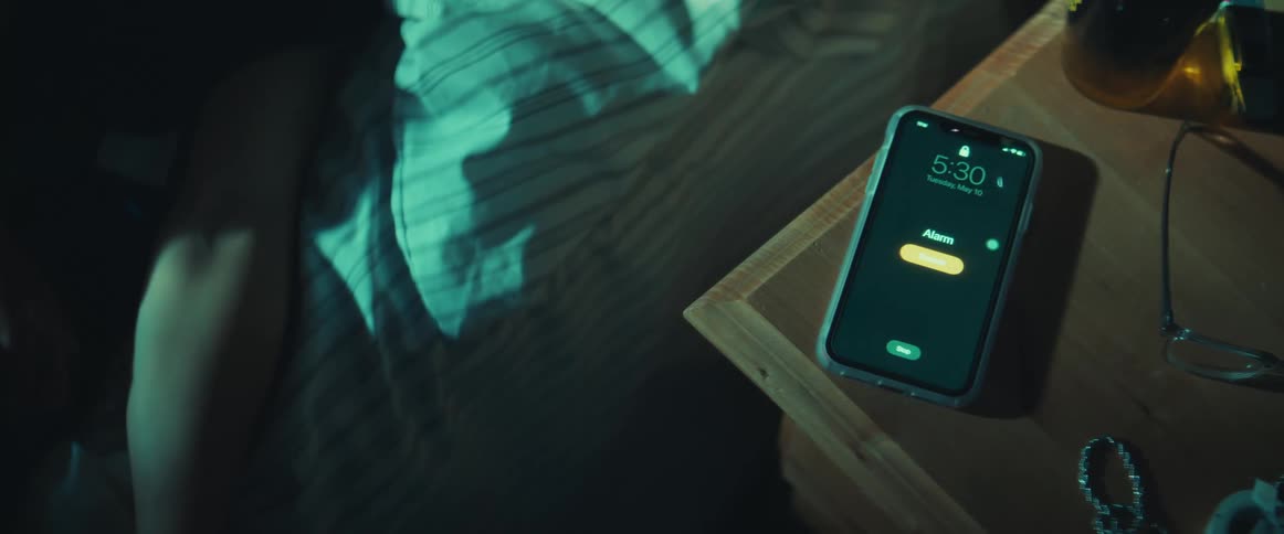 A person turning off an alarm on their phone