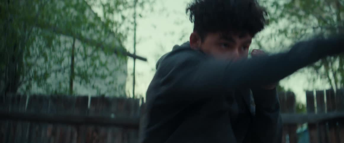 A person shadow boxing outdoors