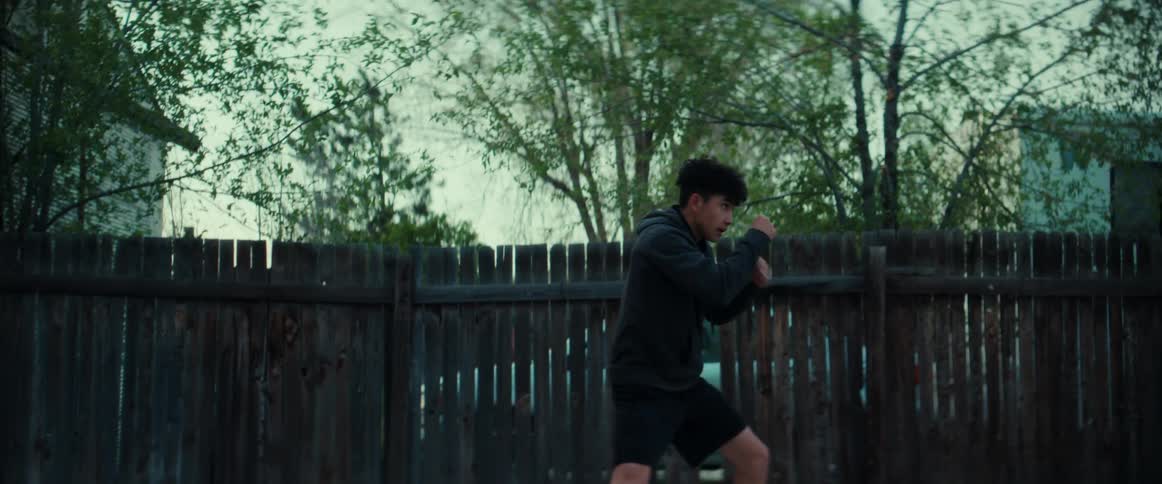 A latino man exercising shadow boxing outdoors