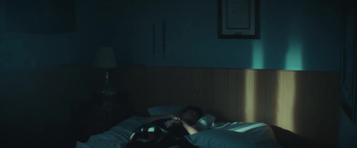 Boy sleeping in his bed wakes up in the morning
