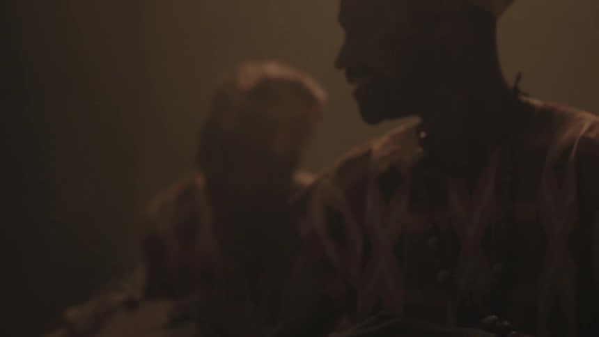 People play drums together in a dark area