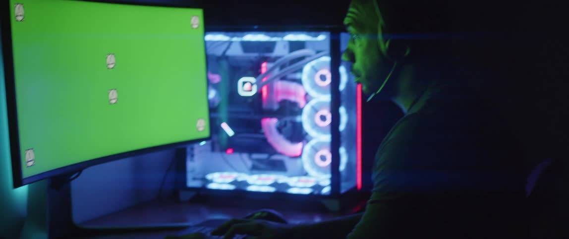 A man sits at his desk and works on his computer