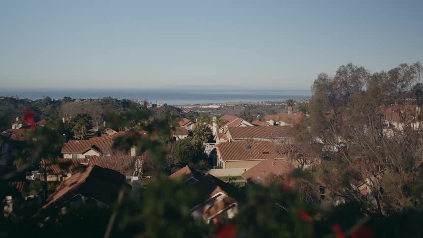 Houses with roof tiles on hill overlooking coast