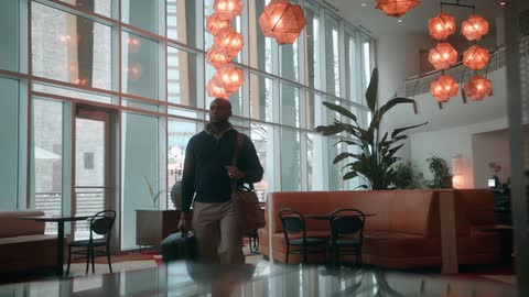 A man walking into a lobby