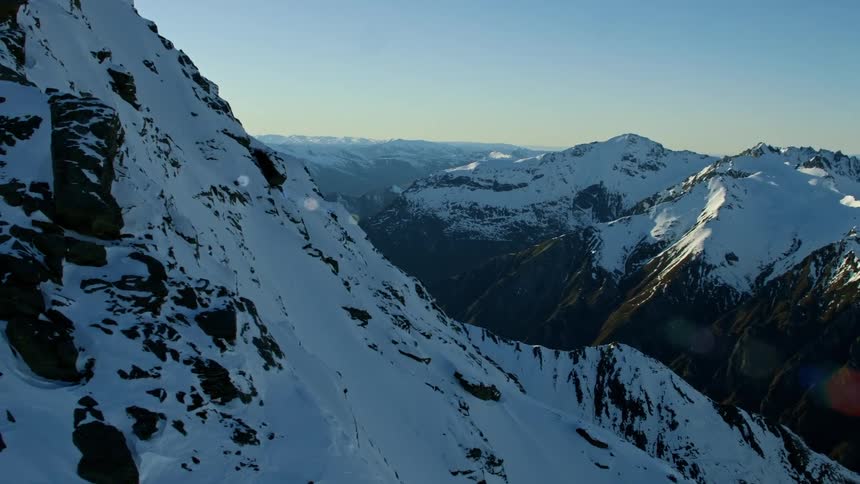 Snow covered mountain ridge and slopes on a sunny day