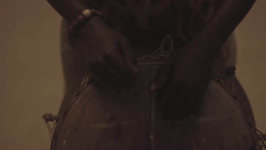 A person is beating a drum