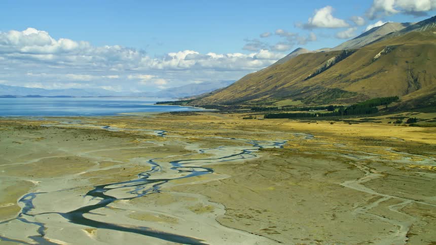 The stream and mountain line the shore