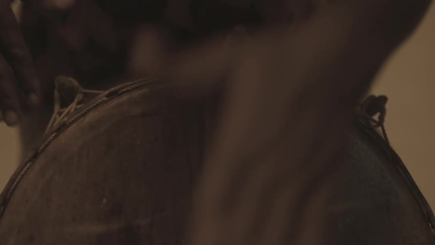 A man using his hands to play a drum