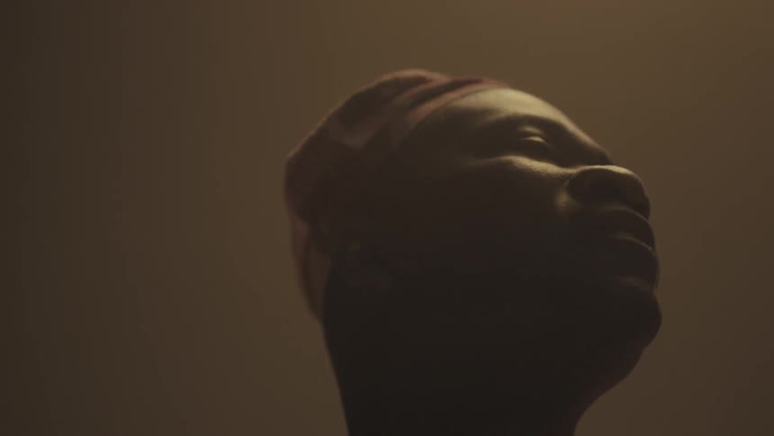 A man smiles and bobs his head