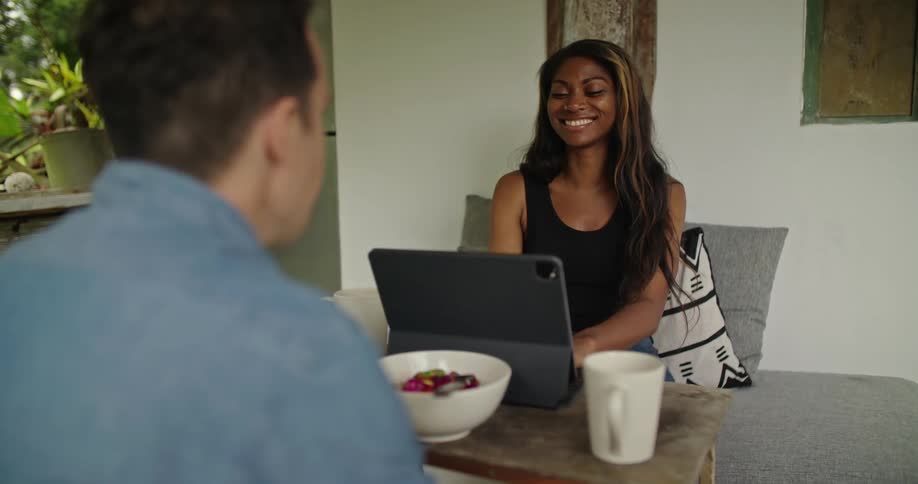 Man and woman are sitting at a table together and talking