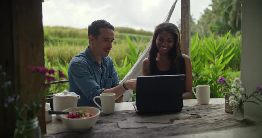 Man and woman are looking at a laptop together