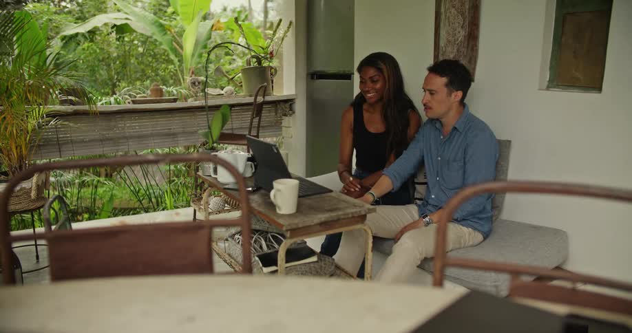A man and woman using a laptop