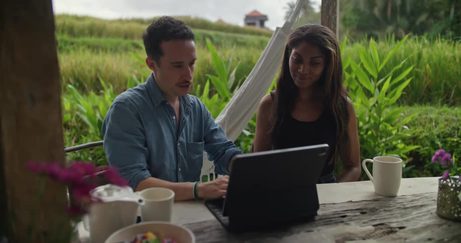 A man and woman using a laptop