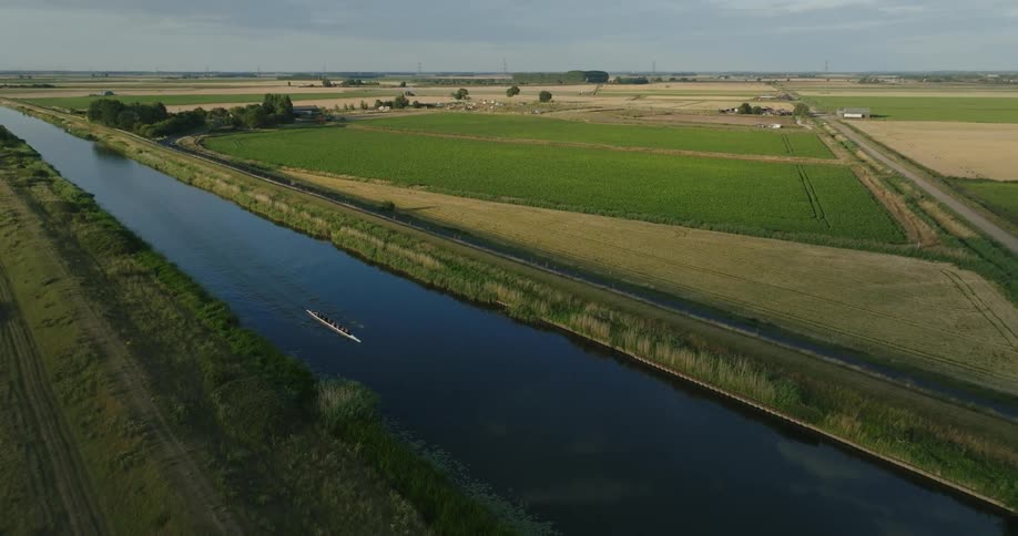 Aerial view of a rowing team next to farm fields