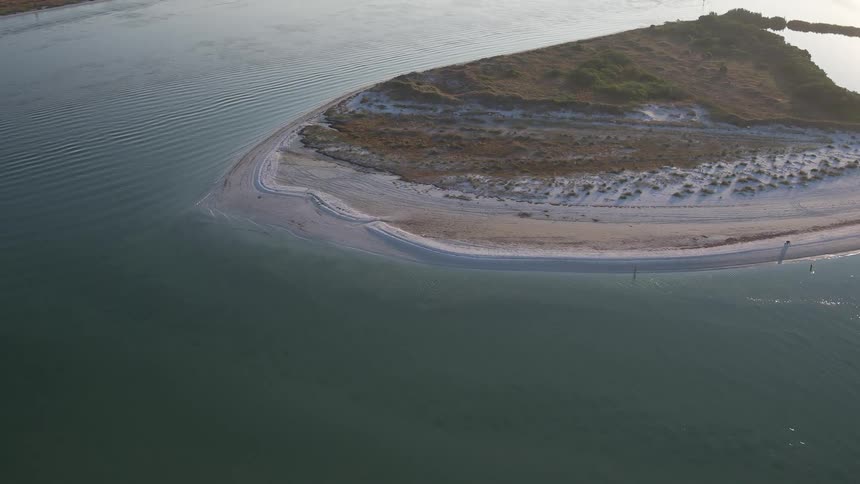 Ocean waves gently flowing towards an island beach