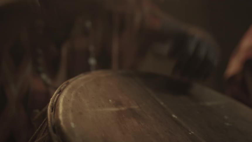 A man is beating a large drum