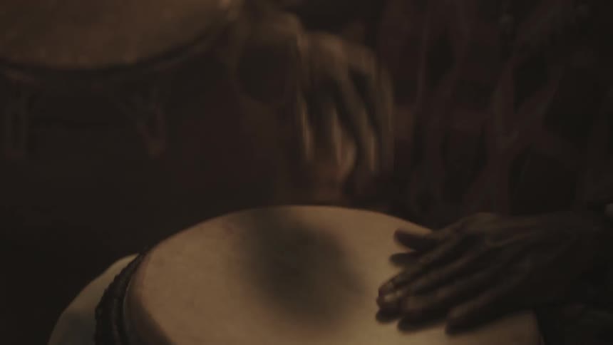 People are beating large drums