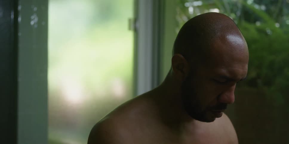 A man wipes his face with a towel