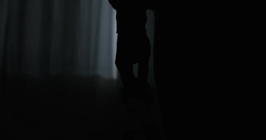 A man is standing facing a window in a childs room