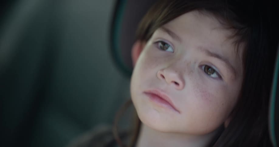 A child is bored while riding in the car