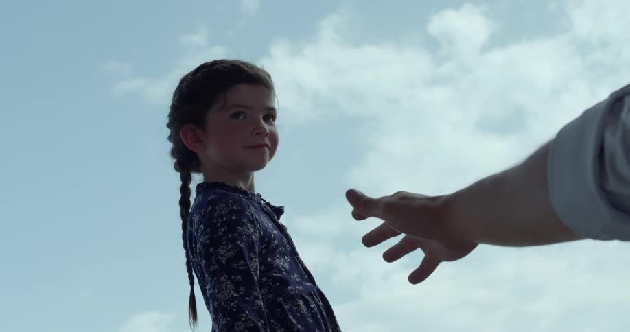 Man extends a hand to girl with braids and blue dress
