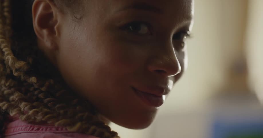 A woman turns her head and looks and smiles