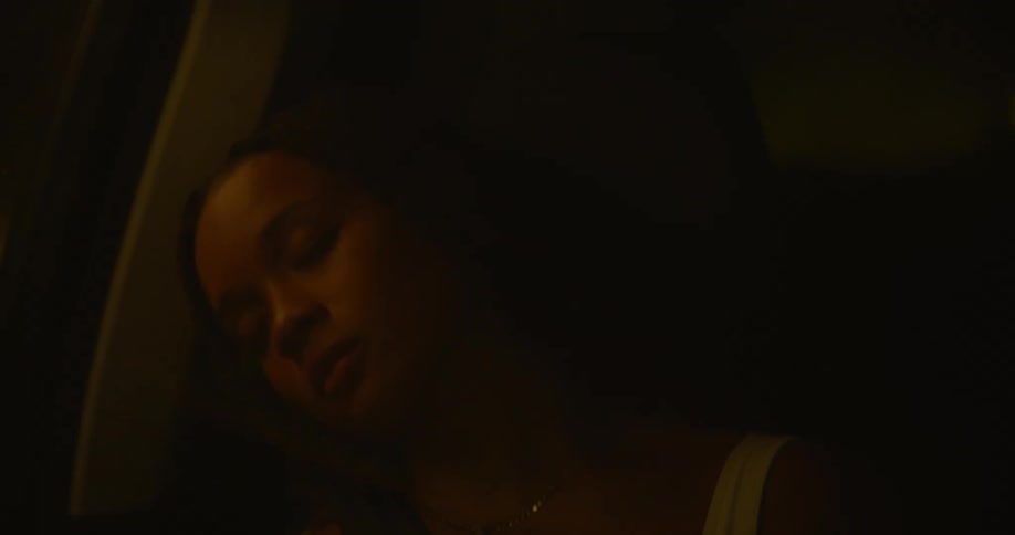 An automobile is traveling as a girl is asleep with her head leaning against the window