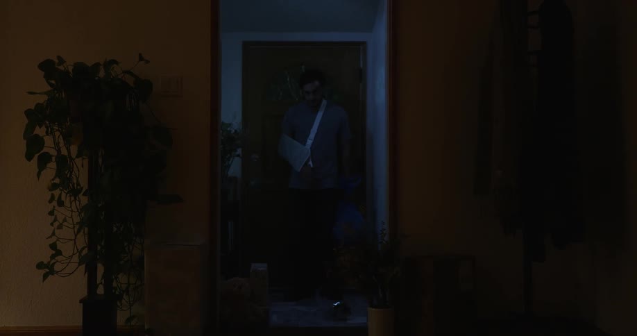 A man enters his home and closes the door