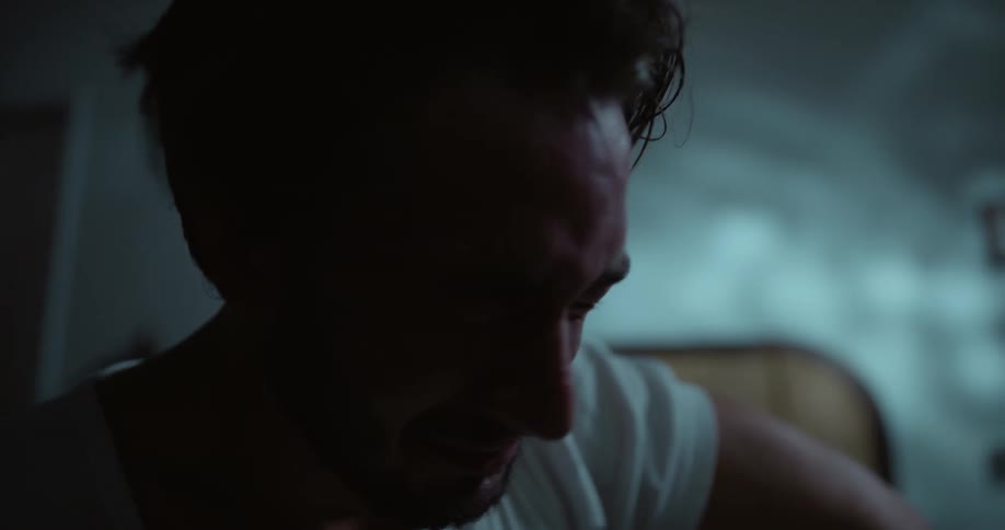 A man is crying as he takes off his glasses and pushes his hair away from his face and puts his hand over his eyes