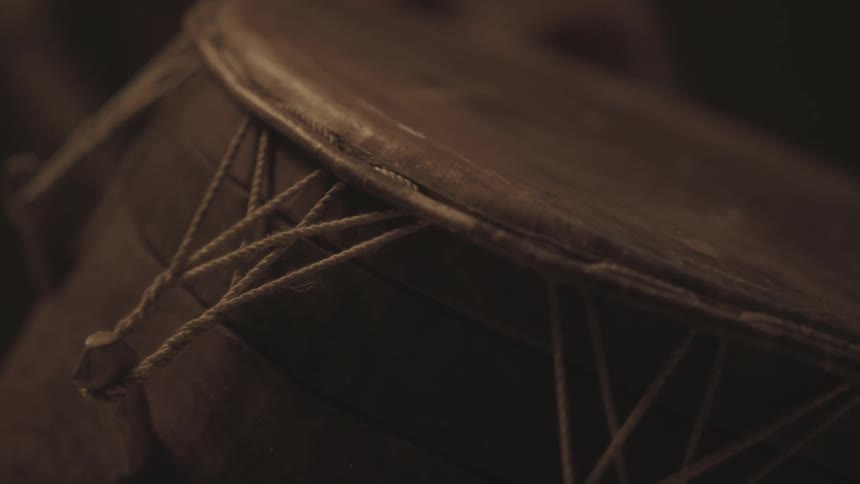 The side of a drum is fastened with string