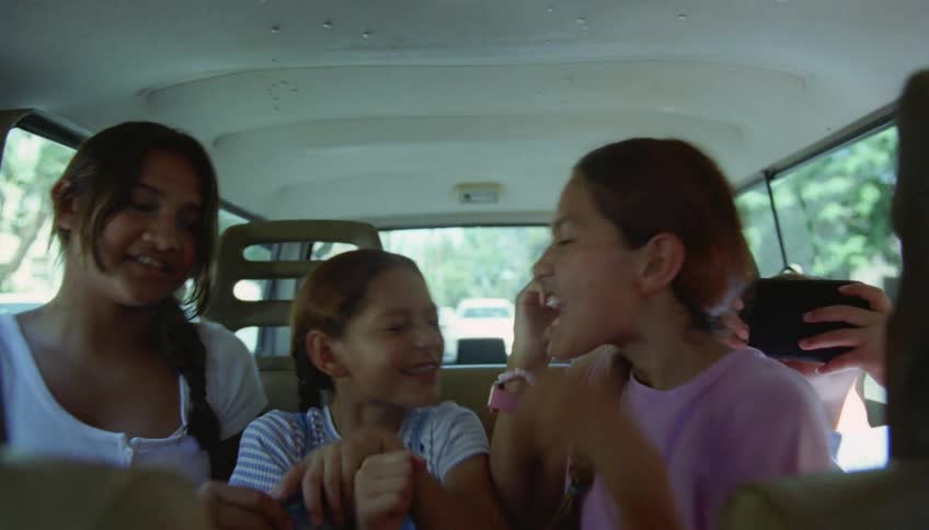 Children are talking in back of the car