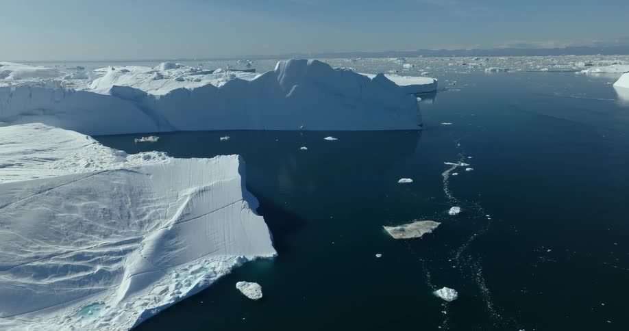 Aerial view of large iceberg in water
