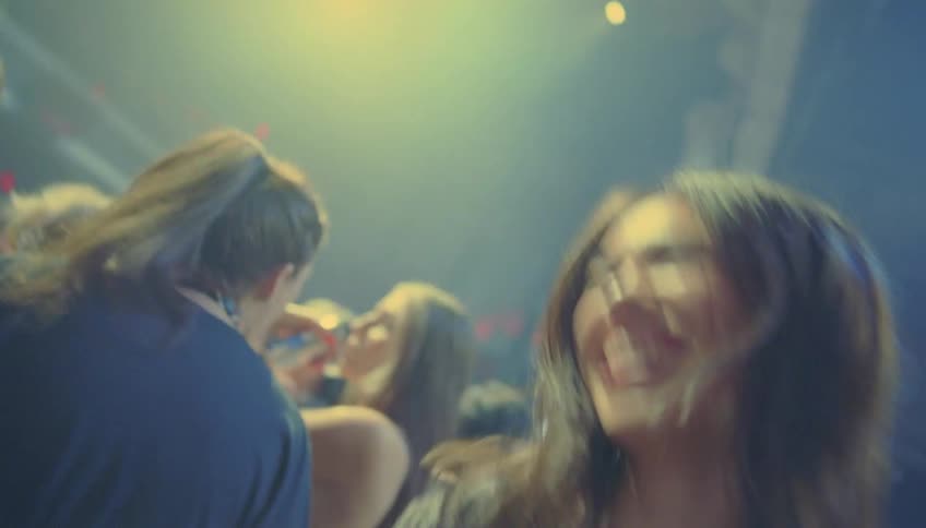 Group of happy friends dancing and jumping on a big party on a night club