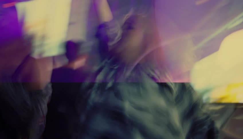 Men and women dance in nightclub with led lights