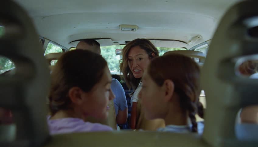 Mother turns around to shut up her chatty daughters on a family road trip