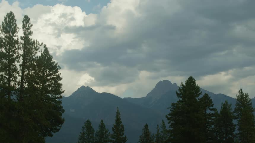 The clouds flow over the mountains