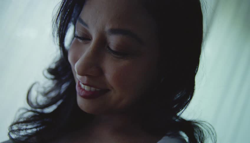A daughter listens to her mothers pregnant stomach
