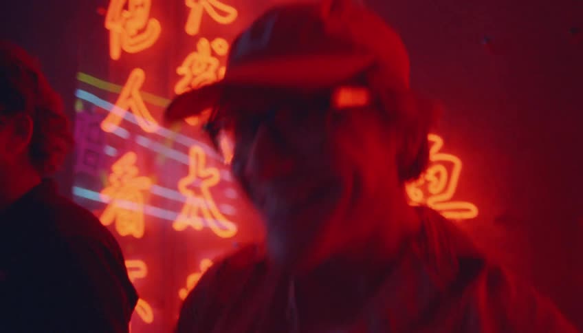 Group of happy friends dancing and singing karaoke on a night club