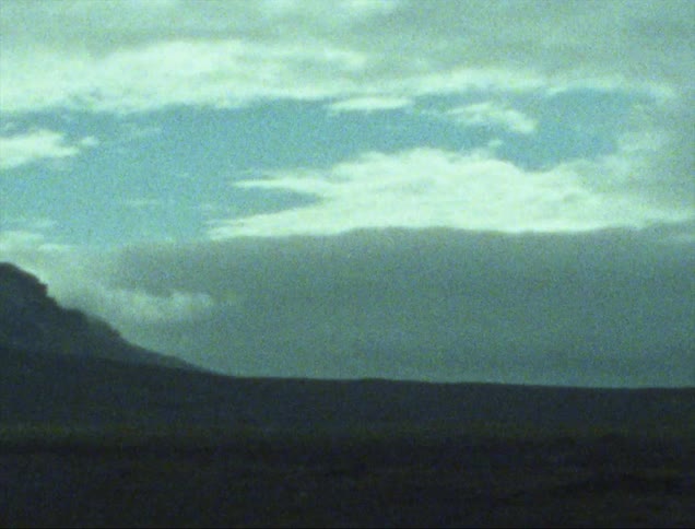 Skies turn dark over an open field