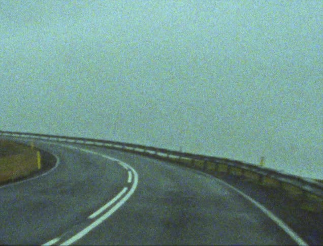 Point of view shot driving up a road on the mountains caught on vintage film