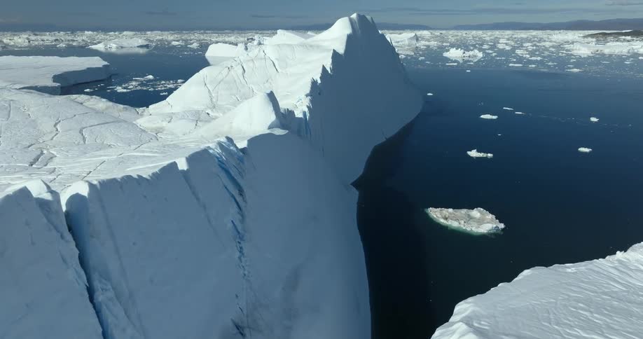 Aerial view of large iceberg floating in the sea