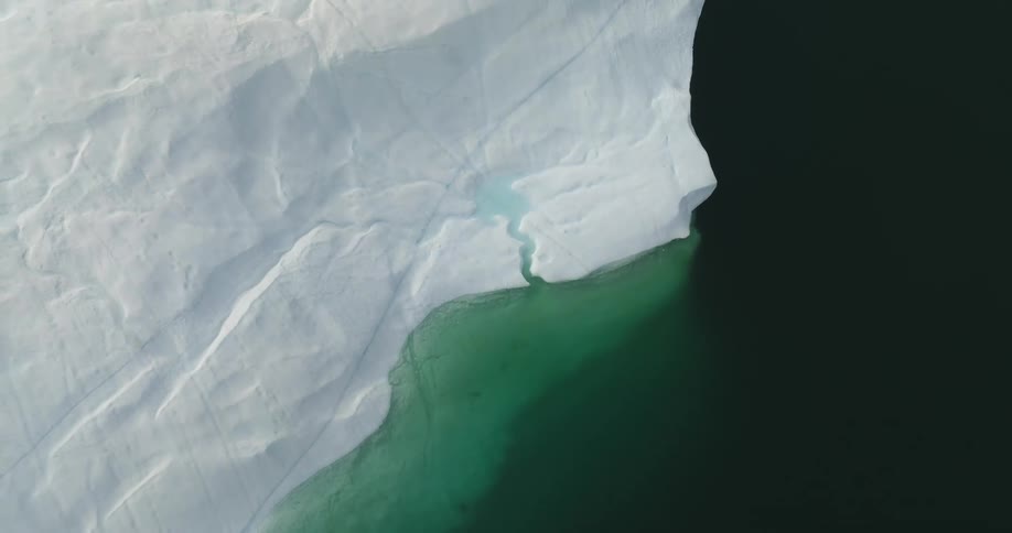 Aerial view of large iceberg floating in sea